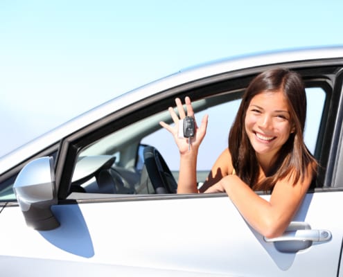 17 year old woman smiling showing new car keys